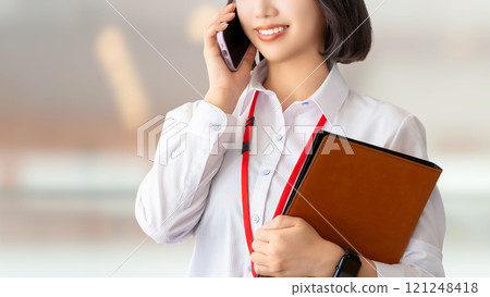 Smiling woman/businesswoman talking on smartphone Smiling woman/businesswoman talking on smartphone 121248418