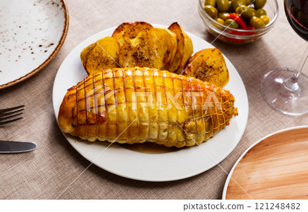Stuffed chicken served with potatoes on platter Stuffed chicken served with potatoes on platter 121248482