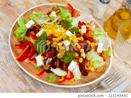 Vegetable salad with corn and bell peppers on a plate 121248492