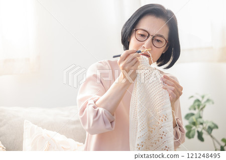 A woman wearing reading glasses 121248495