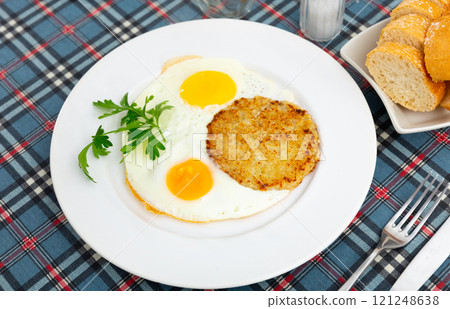 On plate are marrow squash pancakes with fried eggs On plate are marrow squash pancakes with fried eggs 121248638