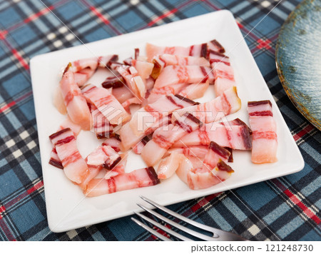 Pieces of lard served on plate 121248730