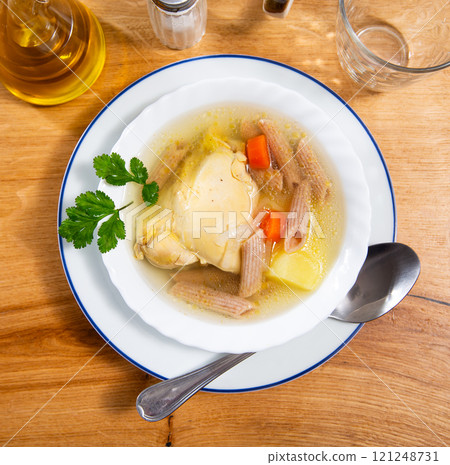 Delicious chicken soup with pasta and carrots Delicious chicken soup with pasta and carrots 121248731