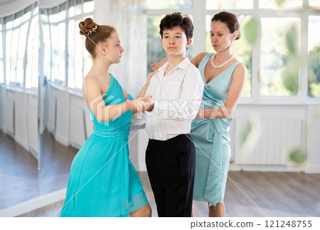 Dance teacher teaches a girl and a boy couples ballroom dancing Dance teacher teaches a girl and a boy couples ballroom dancing 121248755