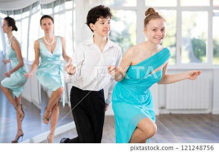 Motivated couple of teen dancers practicing vigorous Lindy Hop Motivated couple of teen dancers practicing vigorous Lindy Hop 121248756