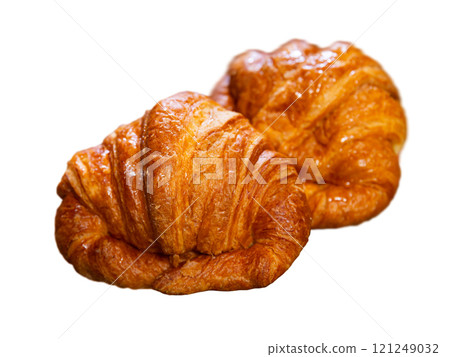 Several twisted croissants with stuffing lie against background of simple table. 121249032