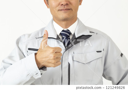 A man wearing work clothes posing good pose on white background A man wearing work clothes posing good pose on white background 121249826