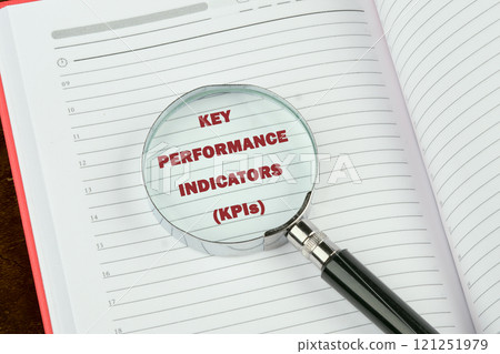 Data analytics automated with AI technology. KEY PERFORMANCE INDICATORS (KPIs) on a blank page of a business notebook through a magnifying glass Data analytics automated with AI technology. KEY PERFORMANCE INDICATORS (KPIs) on a blank page of a business notebook through a magnifying glass 121251979