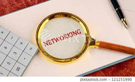 Cybersecurity for Business in the Digital Age. NETWORKING word written in a business book, top view through a magnifying glass Cybersecurity for Business in the Digital Age. NETWORKING word written in a business book, top view through a magnifying glass 121251990