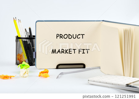 Notepad and writing tools display concept of product market fit in creative workspace Notepad and writing tools display concept of product market fit in creative workspace 121251991