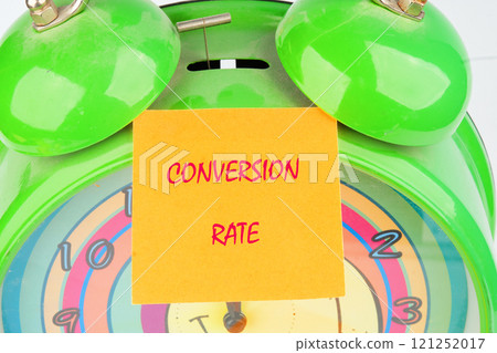 Business concept. The conceptual text of the CONVERSION RATE close-up, on a yellow sticker on the background of an alarm clock 121252017