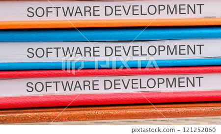 The concept of technology and development. Phrase, words, text SOFTWARE DEVELOPMENT close-up on the ends of the notebooks 121252060