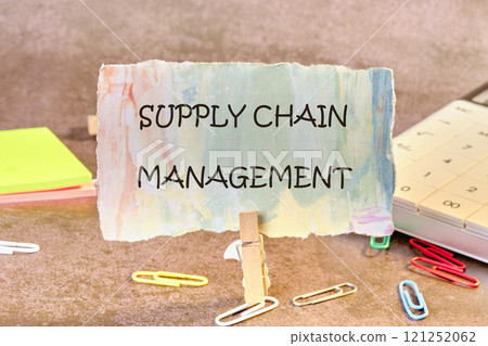 Business concept. SUPPLY CHAIN MANAGEMENT words on a piece of paper in a clothespin Business concept. SUPPLY CHAIN MANAGEMENT words on a piece of paper in a clothespin 121252062