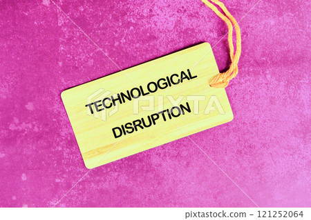 Wooden tag displaying the words technological disruption on a pink background for a creative business concept 121252064