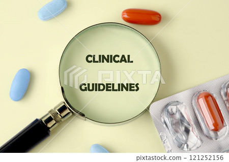 Detailed exploration of clinical guidelines through magnifying lens on a colorful array of pills and capsules 121252156
