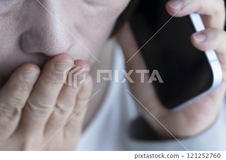 Elderly woman receiving a spoofed phone call on her smartphone Elderly woman receiving a spoofed phone call on her smartphone 121252760