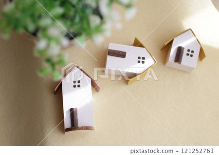 A cute little miniature house placed by a window where light shines in A cute little miniature house placed by a window where light shines in 121252761