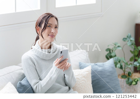 A woman using a smartphone A woman using a smartphone 121253442
