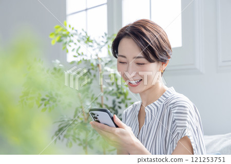 A woman watching a smartphone A woman watching a smartphone 121253751