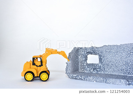 Image of a construction site where a building is being demolished with heavy machinery 121254003
