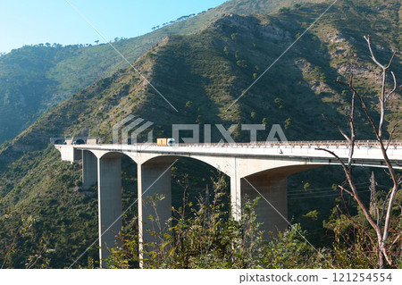Mountain and highway bridge in Liguria. Nature and building structures. Transportation and road network.  121254554
