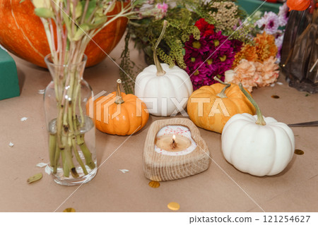 Flower arrangement in a pumpkin, autumn interior decor. Creating handmade autumn decor. Flower arrangement in a pumpkin, autumn interior decor. Creating handmade autumn decor. 121254627