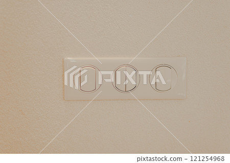 Beige plastic wall mounted electric light switch for three and backplate. Three switches 121254968