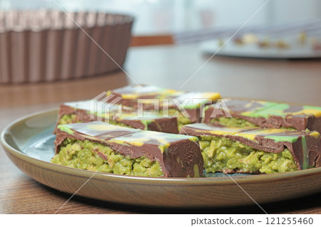 Dubai chocolate bar with pistachio paste and kataifi dough. Confectionery and sweets. 121255460