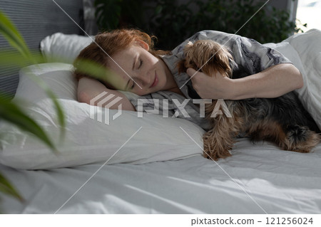 A Cozy Morning with a Beloved Pet A Heartwarming Scene of Relaxation and Comfort 121256024