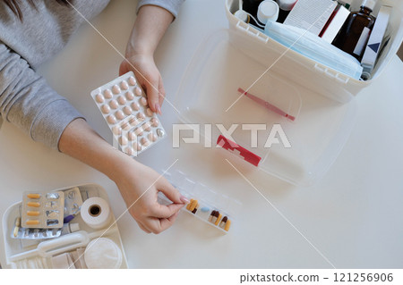 A woman takes her daily sedative or medicine for a headache or stomach pain. A woman takes her daily sedative or medicine for a headache or stomach pain. 121256906