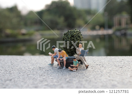 Miniature People Relaxing in Scenic Park Setting Miniature People Relaxing in Scenic Park Setting 121257781