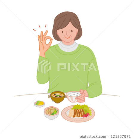 A smiling middle-aged woman (living alone) making a circle pose with her hands while eating A smiling middle-aged woman (living alone) making a circle pose with her hands while eating 121257971