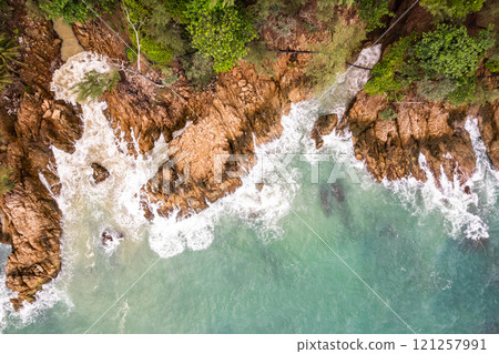 Bird eye view seashore with waves crashing on rock cliff, Beautiful waves sea surface in sunny day summer background, Amazing seascape top view seacoast landscape view Bird eye view seashore with waves crashing on rock cliff, Beautiful waves sea surface in sunny day summer background, Amazing seascape top view seacoast landscape view 121257991