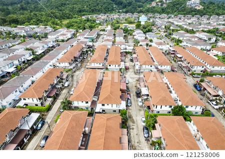 New development real estate. Aerial view of residential houses and driveways neighborhood during a fall sunset or sunrise time. Tightly packed homes. Top view over private houses in phuket thailand New development real estate. Aerial view of residential houses and driveways neighborhood during a fall sunset or sunrise time. Tightly packed homes. Top view over private houses in phuket thailand 121258006
