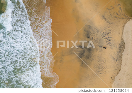 Top view beach with waves crashing on sandy shore,Beautiful waves sea surface in summer seascape background,Amazing beach colorful water background 121258024