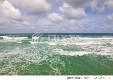 Top view beach with waves crashing on sandy shore,Beautiful waves sea surface in summer seascape background,Amazing beach colorful water background 121258025