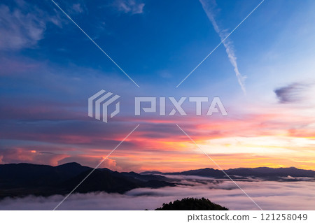 Amazing Sunrise or sunset over mountains hills covered with mist, Aerial view landscape drone shot beautiful colorful nature background 121258049