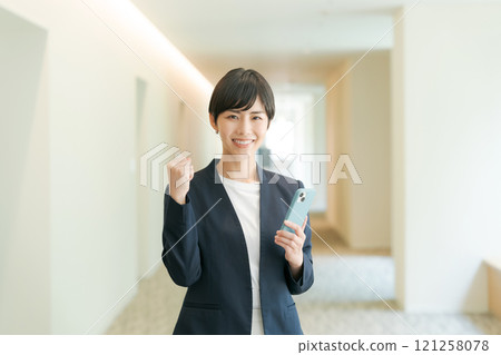 A woman in a suit that makes a guts pose A woman in a suit that makes a guts pose 121258078