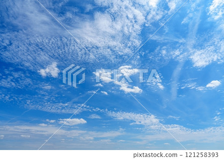 Stunning Blue Sky Background Featuring Fluffy White Clouds on a Bright Sunny Day in Nature s Beauty 121258393