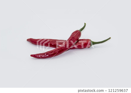 Two Chili peppers isolated on white background. Hot ripen chili peppers without GMO. Organic mexican spices Two Chili peppers isolated on white background. Hot ripen chili peppers without GMO. Organic mexican spices 121259637