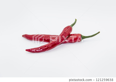Two Chili peppers isolated on white background. Hot ripen chili peppers without GMO. Organic mexican spices Two Chili peppers isolated on white background. Hot ripen chili peppers without GMO. Organic mexican spices 121259638