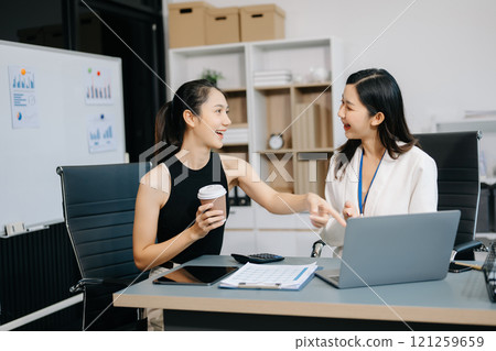 Two businesswoman and man discuss investment project working and planning strategy with tablet laptop computer 121259659
