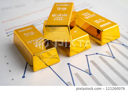 Gold bars on graph paper, finance trading investment business currency. Gold bars on graph paper, finance trading investment business currency. 121260076