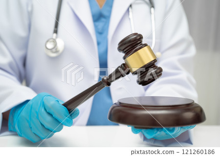 Asian doctor holding court hammer for and crime law justice, forensic medicine. Asian doctor holding court hammer for and crime law justice, forensic medicine. 121260186