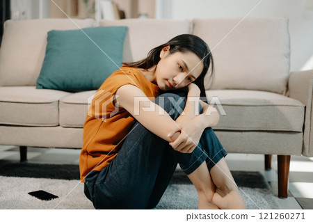 woman sit Depression Dark haired pensive glance Standing on sofa by window woman sit Depression Dark haired pensive glance Standing on sofa by window 121260271