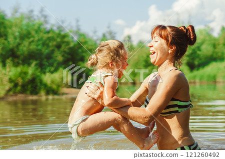 mom and child swim in the river 121260492