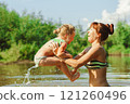 mom and child swim in the river 121260496