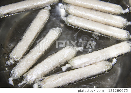 Process boil sausages in the hot water. Fragrant fresh sausages made from chicken meat at home non-GMO in the saucepan with hot water. Ukrainian tasty food. Boiled handmade sausages in the saucepan. 121260675