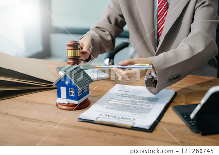 Real Estate Lawyer And House Foreclosure Law. House model, hammer judge gavel on table with white background. Foreclosure, bankruptcy concept Real Estate Lawyer And House Foreclosure Law. House model, hammer judge gavel on table with white background. Foreclosure, bankruptcy concept 121260745