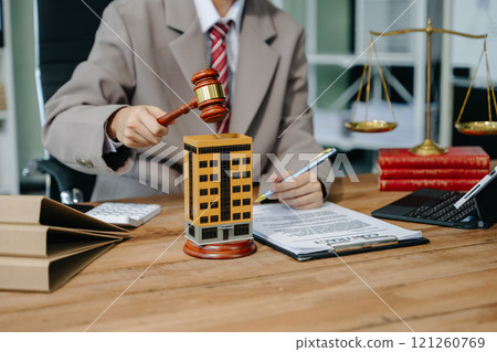Real Estate Lawyer And House Foreclosure Law. House model, hammer judge gavel on table with white background. Foreclosure, bankruptcy concept Real Estate Lawyer And House Foreclosure Law. House model, hammer judge gavel on table with white background. Foreclosure, bankruptcy concept 121260769